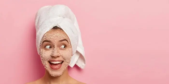 woman_exfoliating_her_skin_smiling